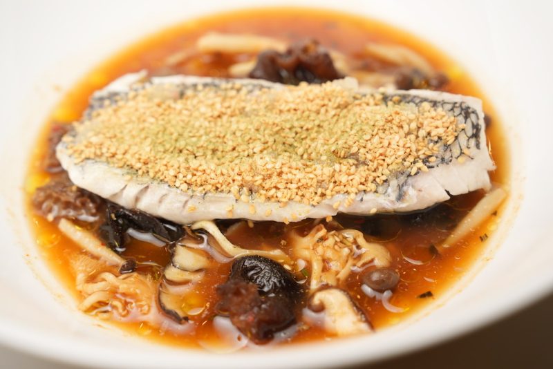 steamed black bass, winter mushrooms, and spiced broth flavored with finger lime, sesame, and rosemary